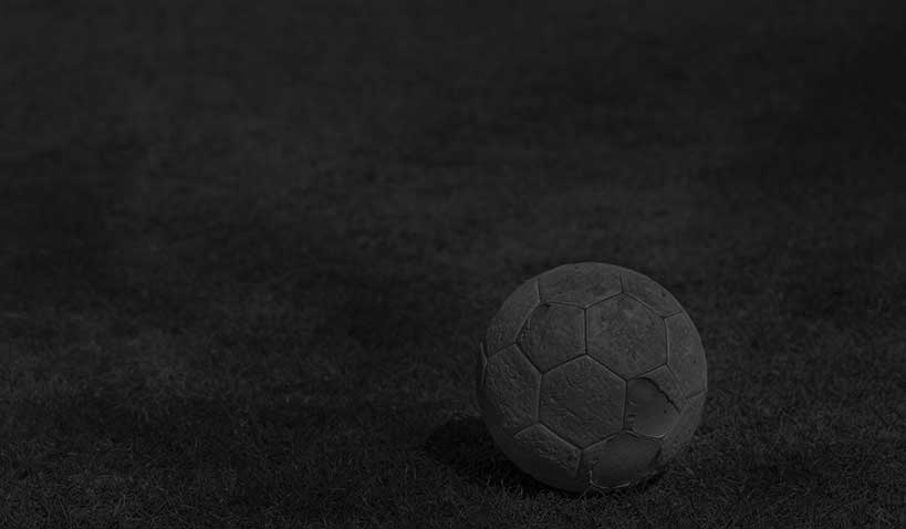 En fotboll på mörk fotbollsplan