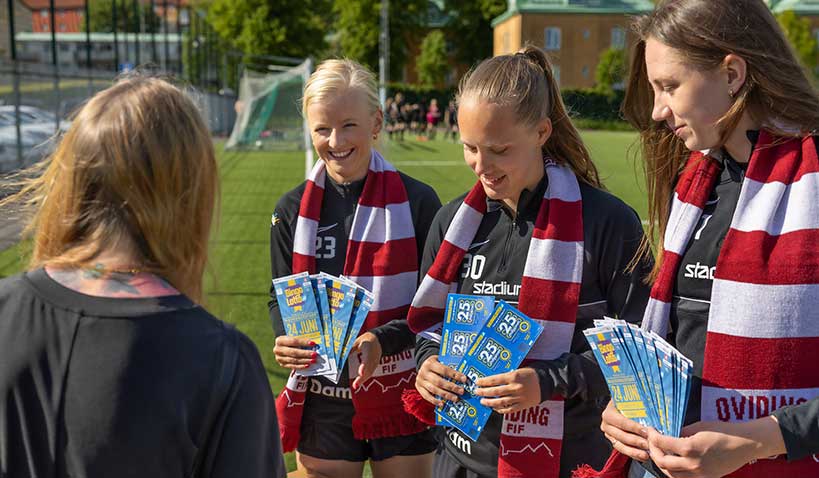 Glada fotbollsspelare som tjänar pengar på att sälja Folkspels lotter